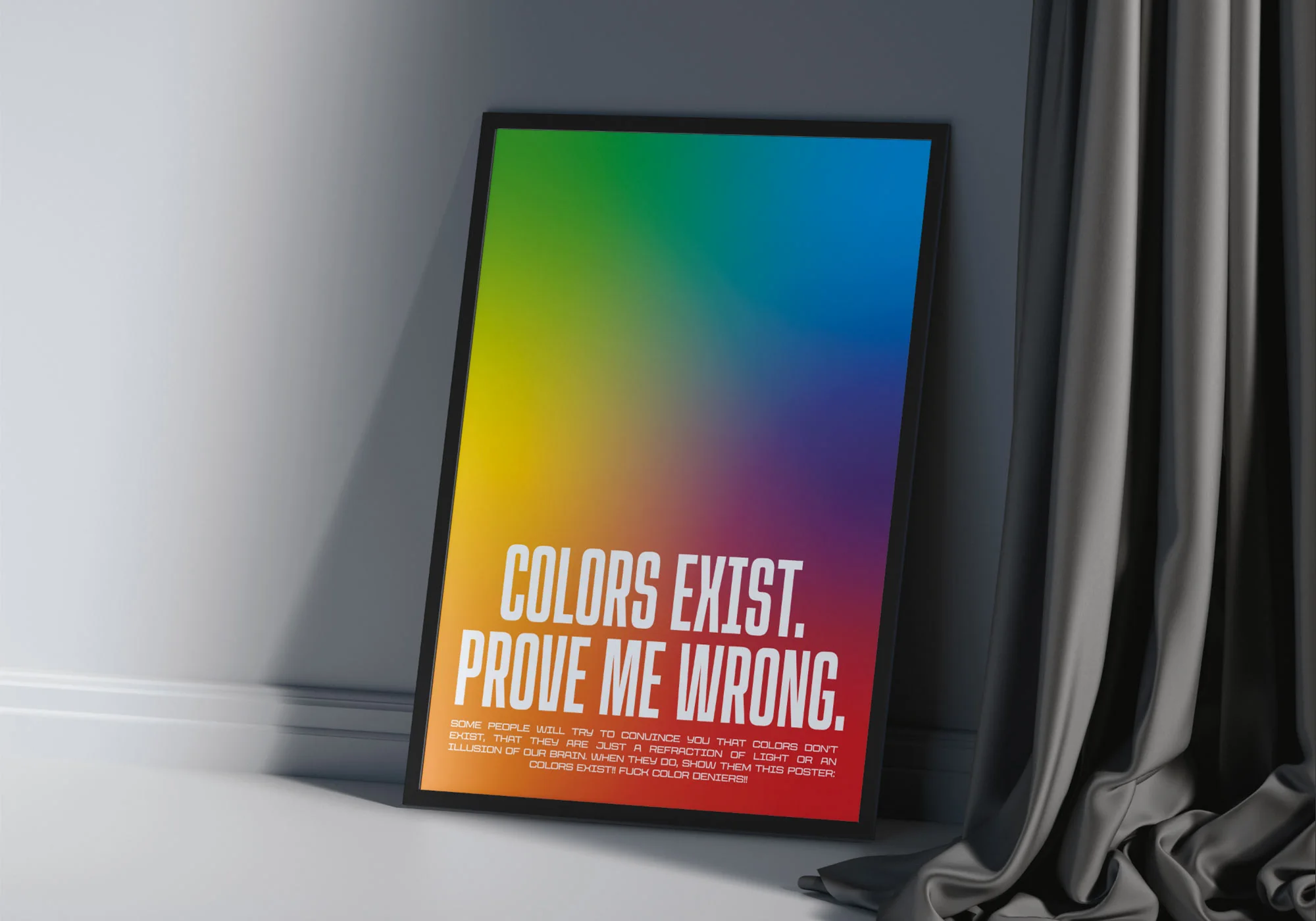 poster di Colors Exist incorniciato in una cornice nera ed appoggiato ad un muro bianco
